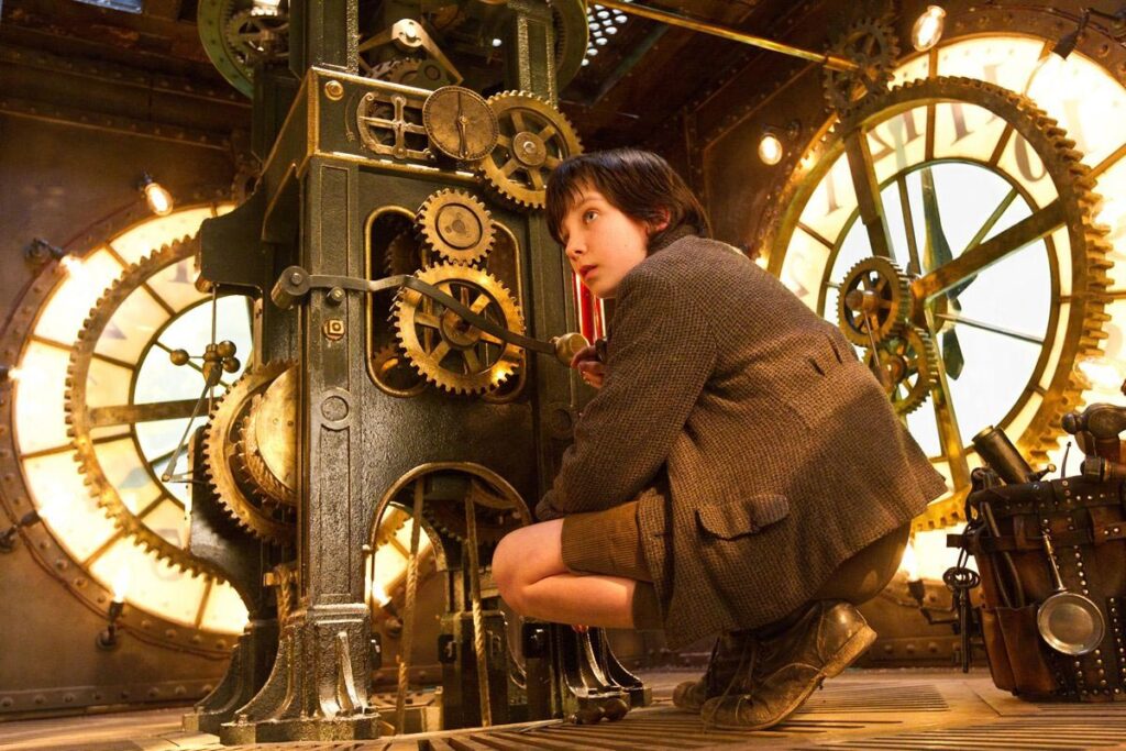 Hugo movie scene, young boy standing beside machine