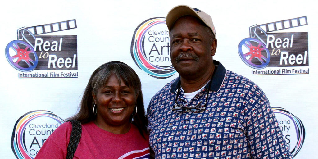 Two people standing together at the Reel to Reel International Film Festival