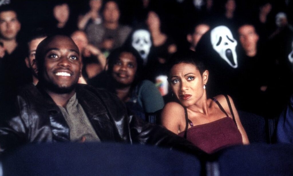 man and woman in movie theatre from the movie scream